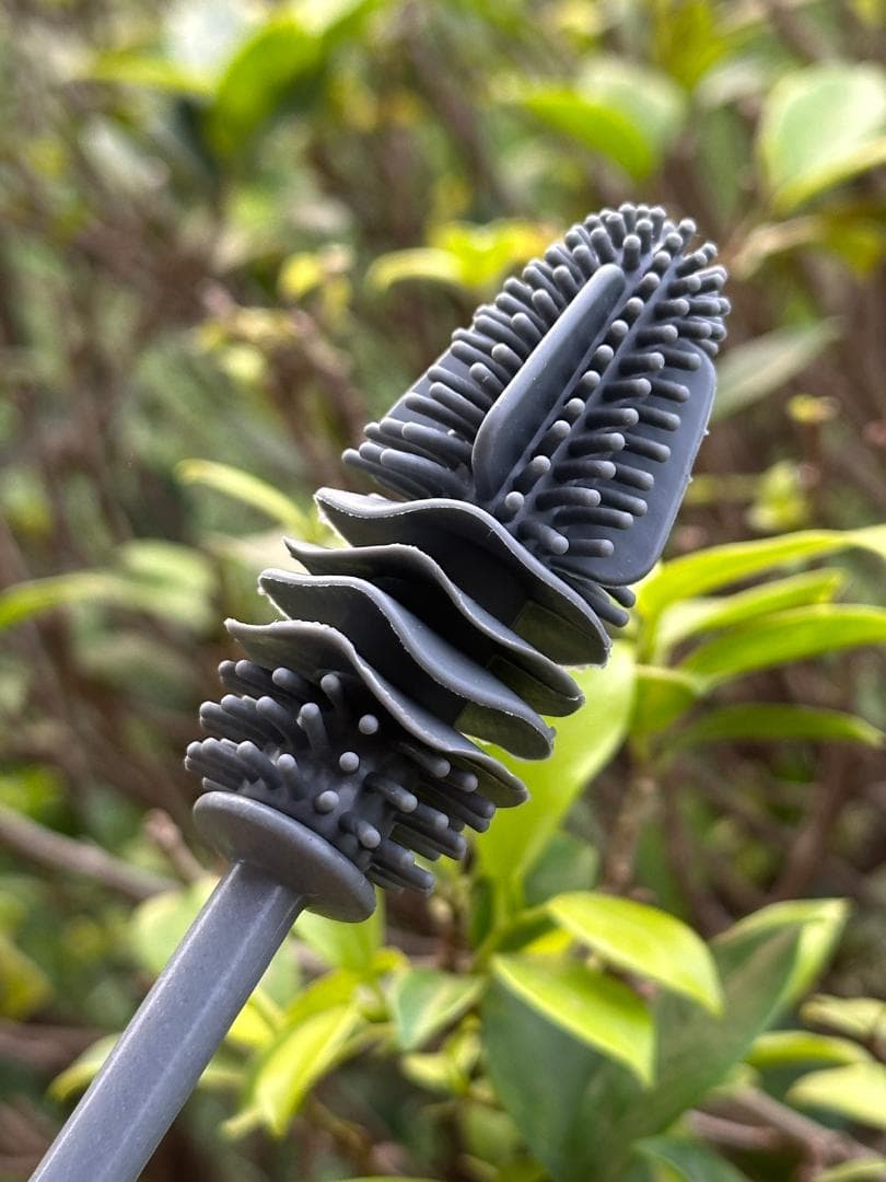 Close-up of the silicone bristle head on the NAX bottle brush