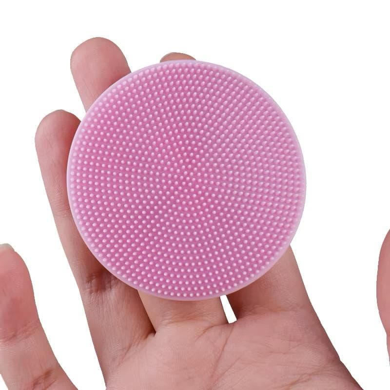 NAX silicone facial cleansing massager held in the hand
